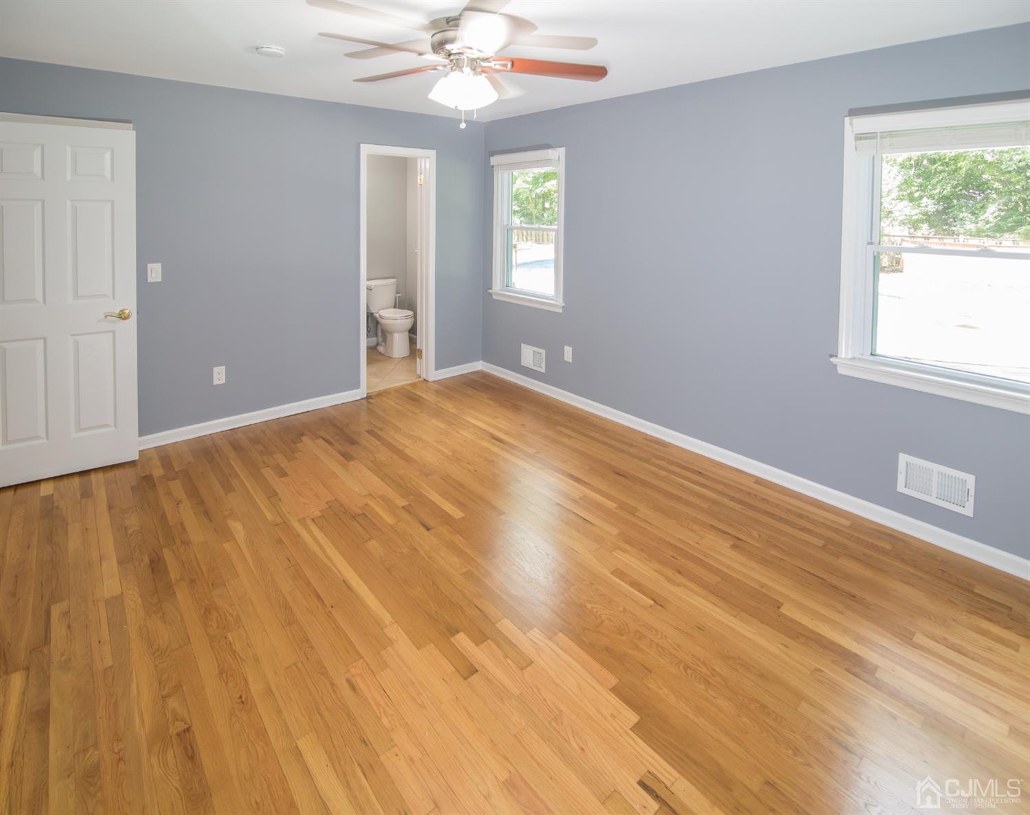 6 Coventry Square Holmdel, NJ 07733 - Photo 18 of 36 a view of empty room with wooden floor and fan