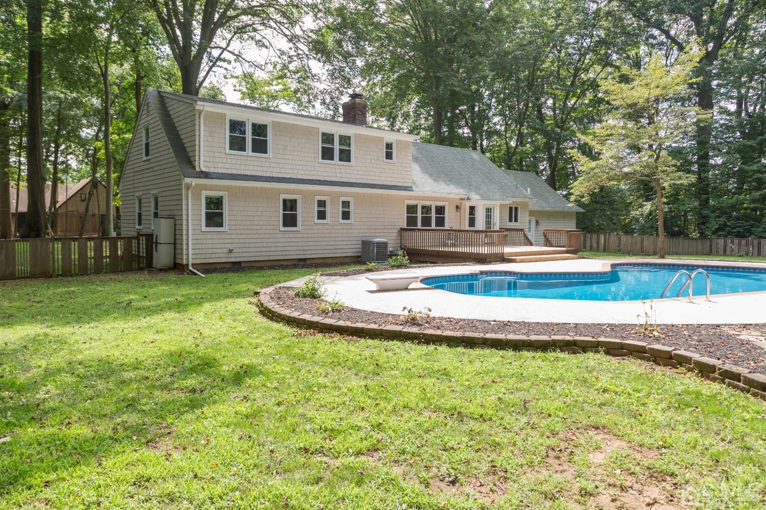 6 Coventry Square Holmdel, NJ 07733 - Photo 3 of 36 a view of house with swimming pool and yard