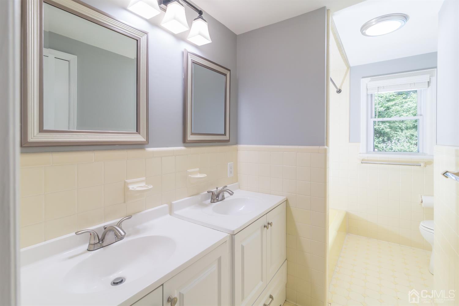 6 Coventry Square Holmdel, NJ 07733 - Photo 27 of 36 a bathroom with a sink a vanity and a mirror