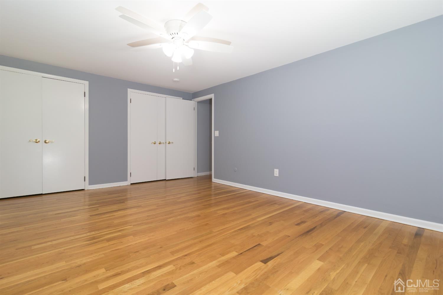 6 Coventry Square Holmdel, NJ 07733 - Photo 30 of 36 a view of an empty room and chandelier fan