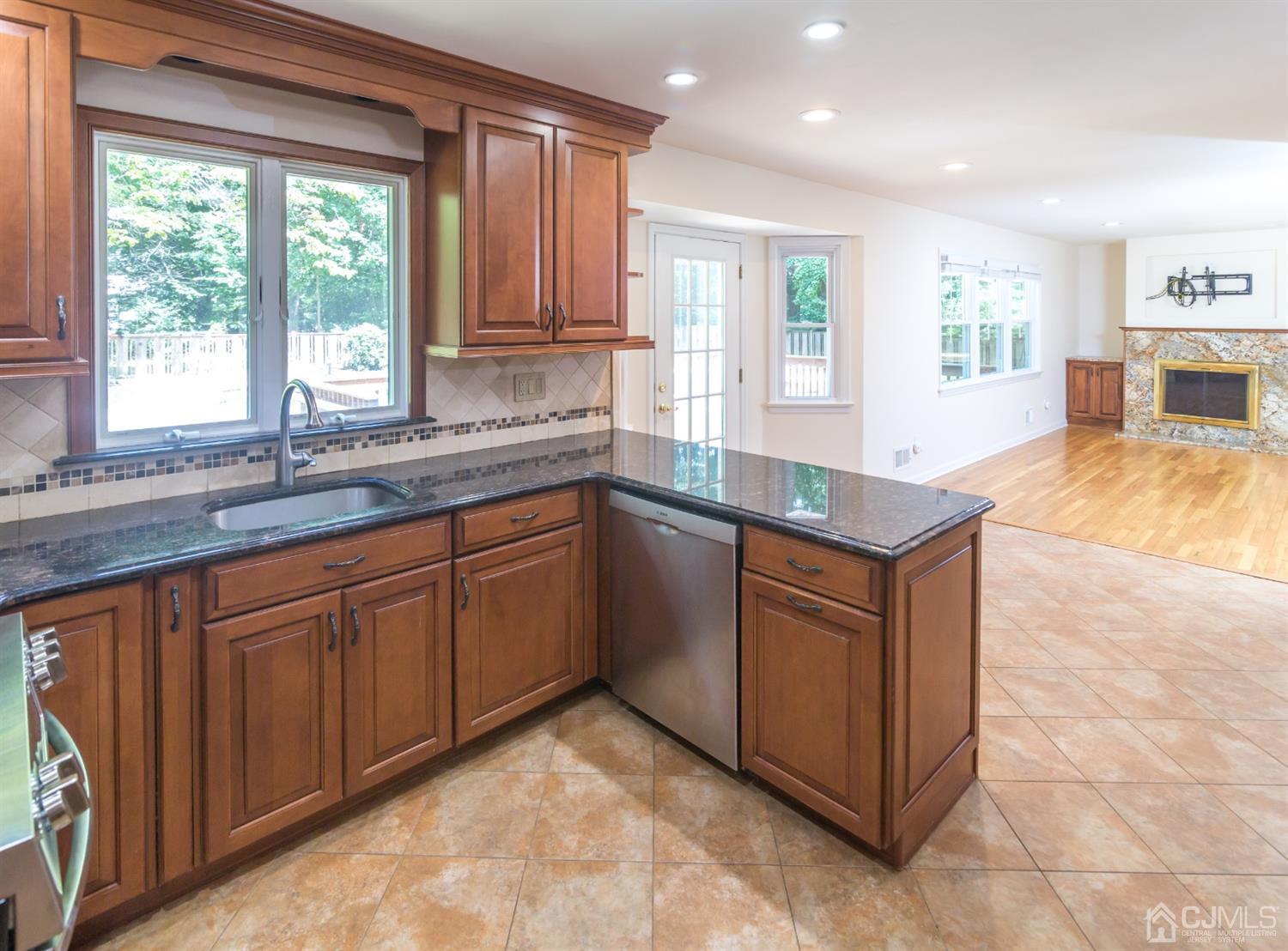 6 Coventry Square Holmdel, NJ 07733 - Photo 6 of 36 a kitchen with stainless steel appliances granite countertop a sink stove and cabinets