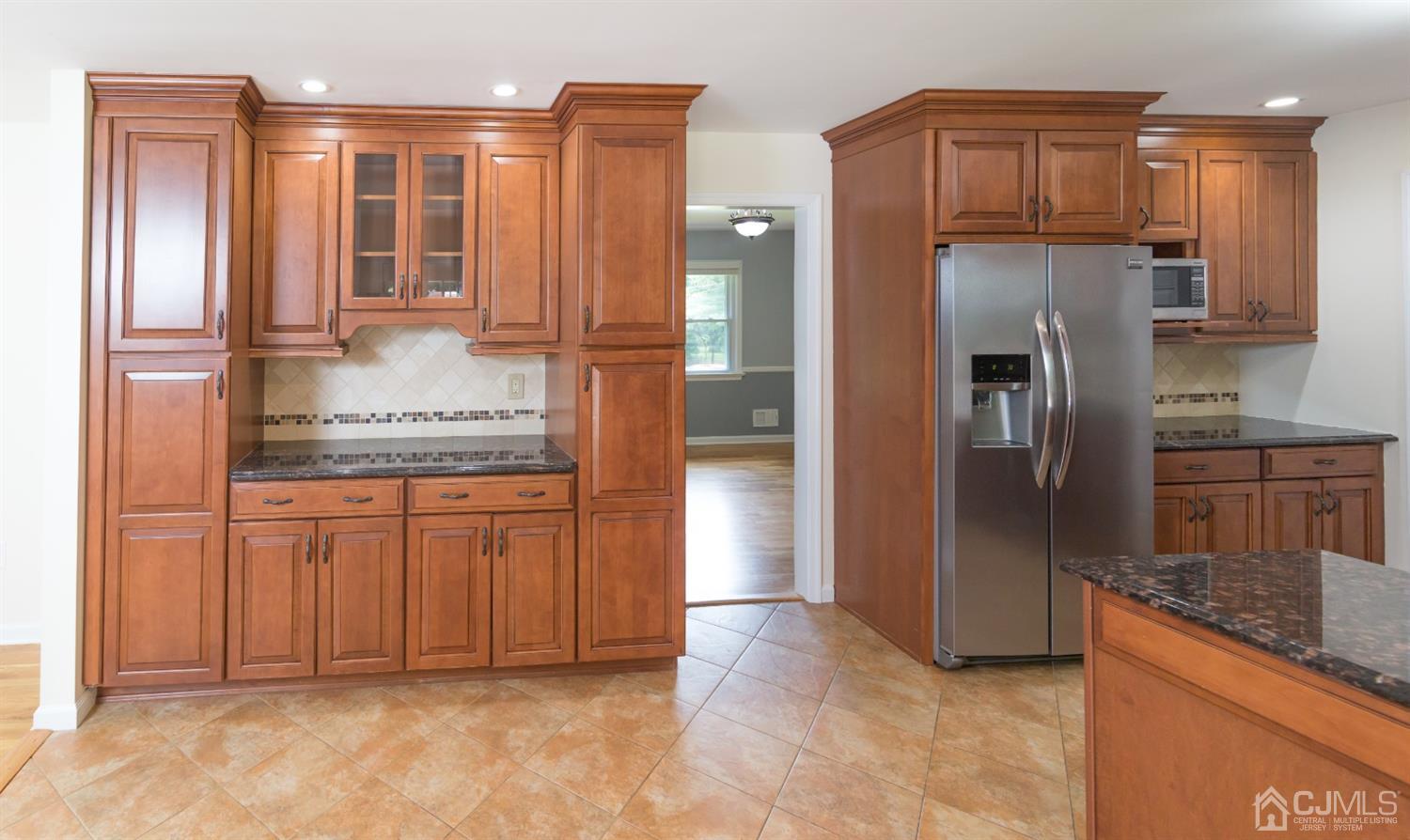 6 Coventry Square Holmdel, NJ 07733 - Photo 7 of 36 a kitchen with stainless steel appliances granite countertop a refrigerator and a sink