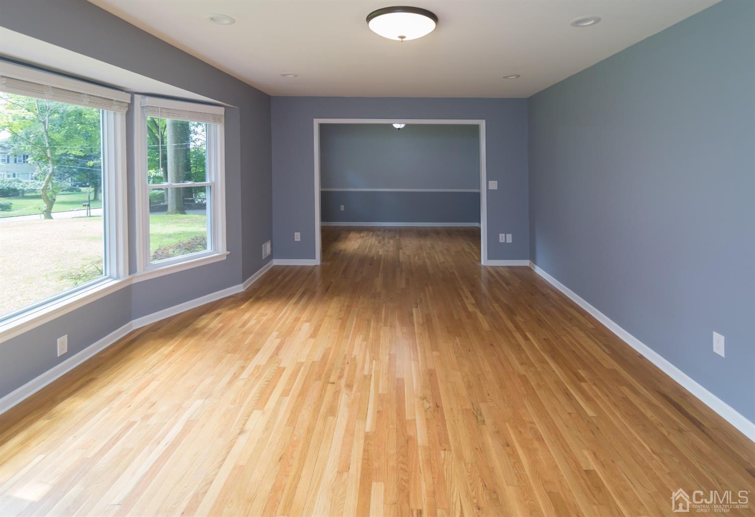 6 Coventry Square Holmdel, NJ 07733 - Photo 10 of 36 a view of empty room with wooden floor and fan