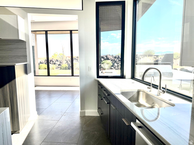 1500 Split Rock, Unit 150 Ivins, UT 84738 - Photo 8 of 18 Kitchen sink area featuring an undermount stainless steel sink, a gooseneck faucet, and light-toned countertops