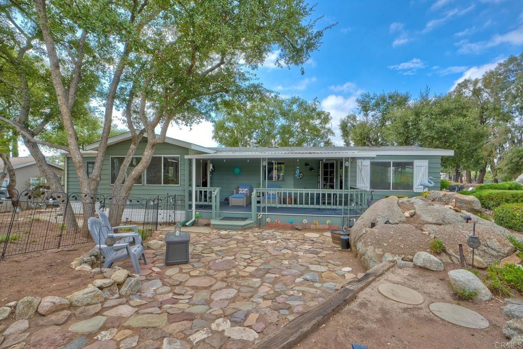 18218 Paradise Mountain Road Valley Center, CA 92082 - Photo 1 of 42 a front view of house with yard outdoor seating and barbeque oven