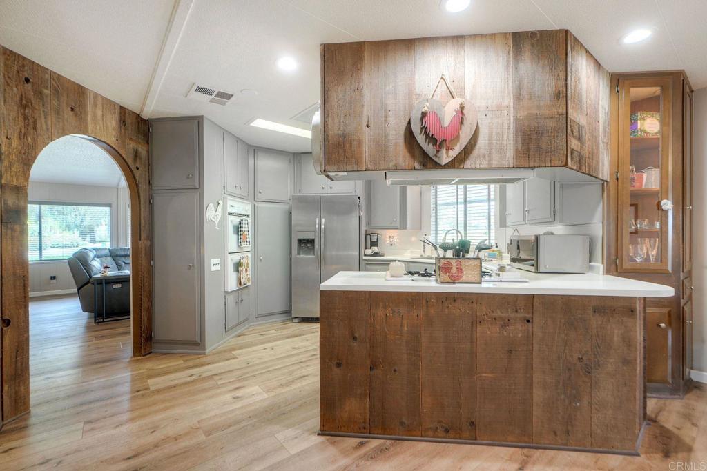18218 Paradise Mountain Road Valley Center, CA 92082 - Photo 17 of 42 a kitchen with stainless steel appliances granite countertop a stove and a wooden cabinets