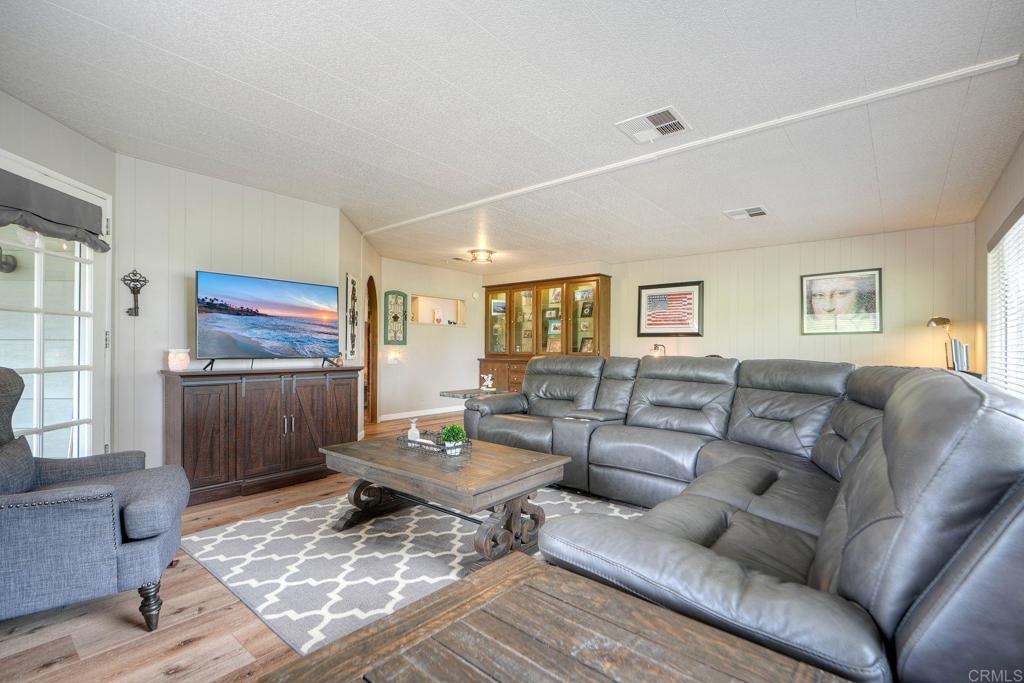 18218 Paradise Mountain Road Valley Center, CA 92082 - Photo 22 of 42 a living room with furniture and a flat screen tv