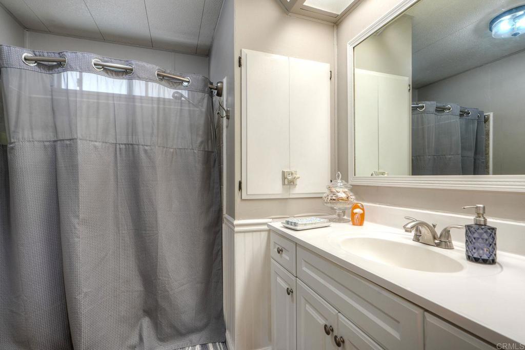 18218 Paradise Mountain Road Valley Center, CA 92082 - Photo 23 of 42 a bathroom with a sink and a mirror