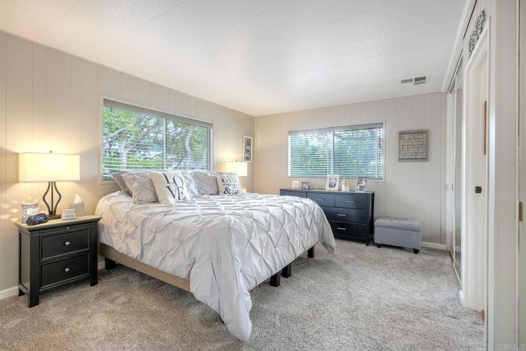 18218 Paradise Mountain Road Valley Center, CA 92082 - Photo 26 of 42 a bedroom with a bed and a night stand