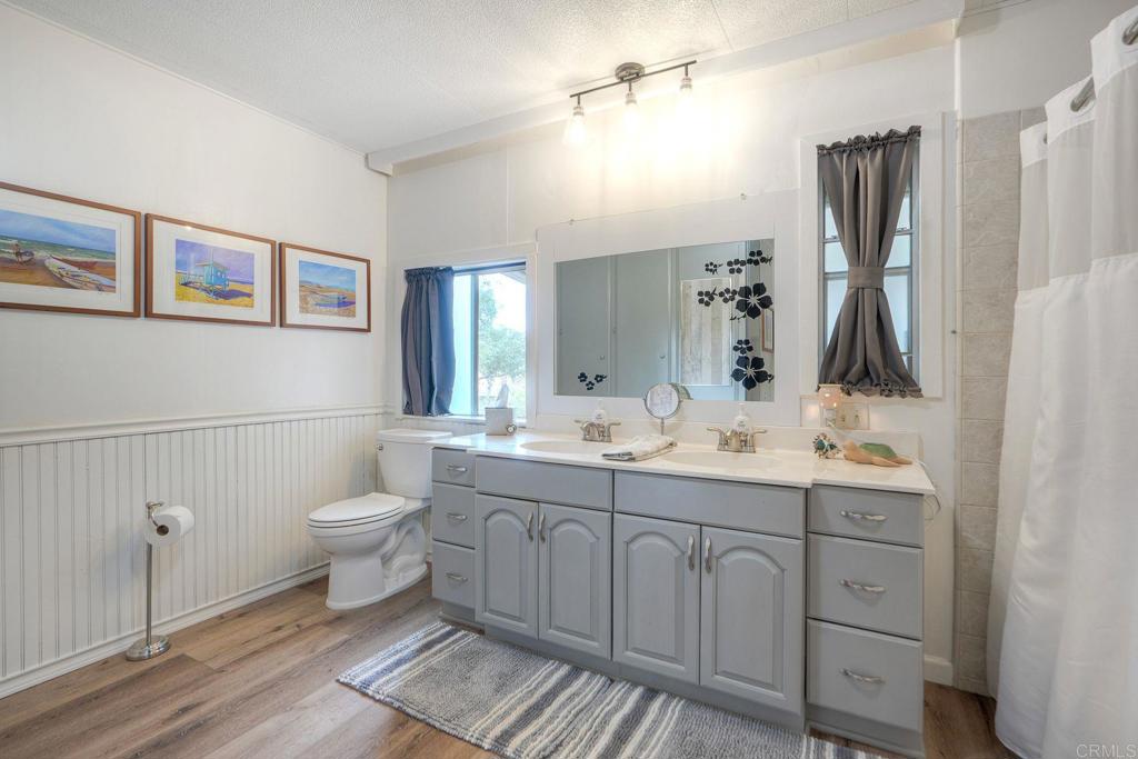 18218 Paradise Mountain Road Valley Center, CA 92082 - Photo 29 of 42 a bathroom with a toilet sink and mirror