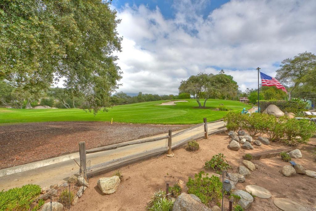 18218 Paradise Mountain Road Valley Center, CA 92082 - Photo 33 of 42 a view of a street with a yard and fence