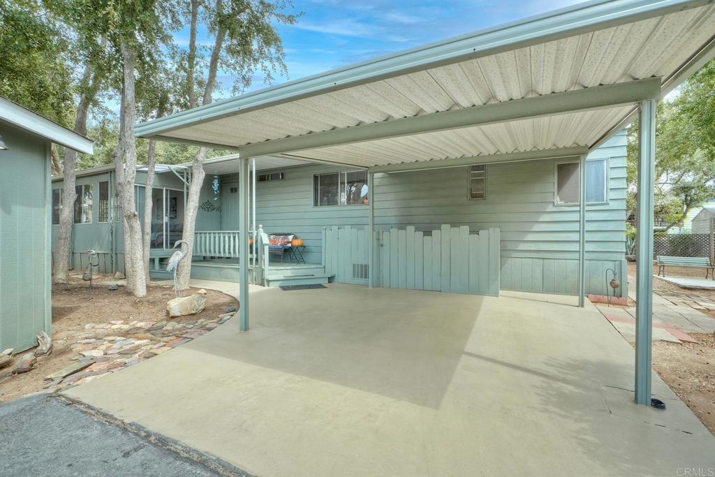 18218 Paradise Mountain Road Valley Center, CA 92082 - Photo 37 of 42 a view of a house with a patio and a yard