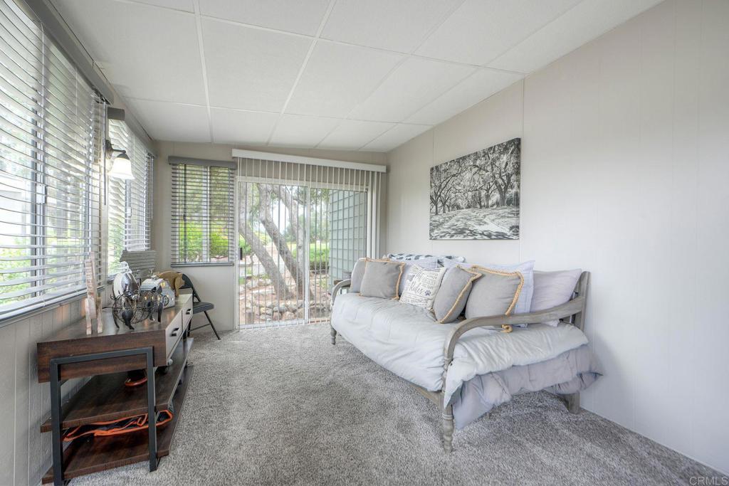 18218 Paradise Mountain Road Valley Center, CA 92082 - Photo 5 of 42 a living room with furniture and a large window with backyard view