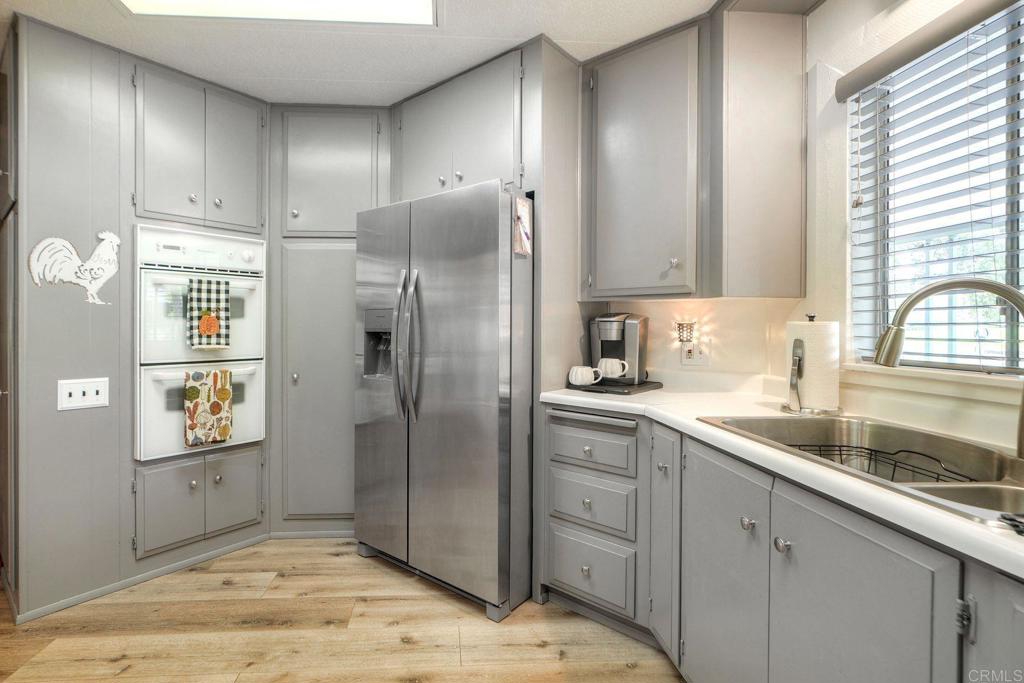 18218 Paradise Mountain Road Valley Center, CA 92082 - Photo 9 of 42 a kitchen with stainless steel appliances granite countertop a refrigerator and a sink