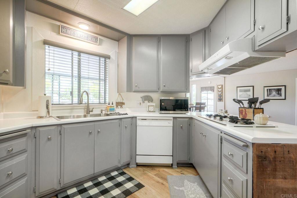 18218 Paradise Mountain Road Valley Center, CA 92082 - Photo 10 of 42 a kitchen with a sink stove and cabinets