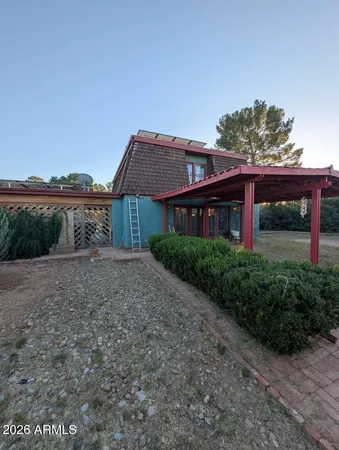 a front view of a house with a yard and potted plants