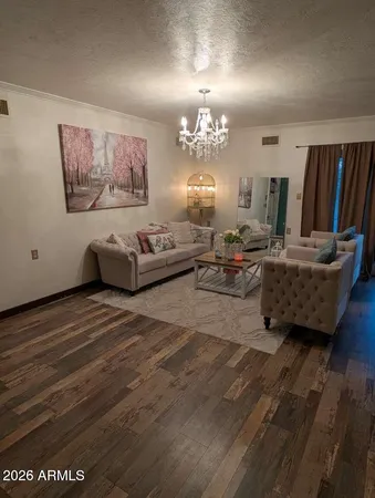 a living room with furniture and a chandelier