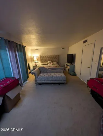 a bedroom with furniture and a window