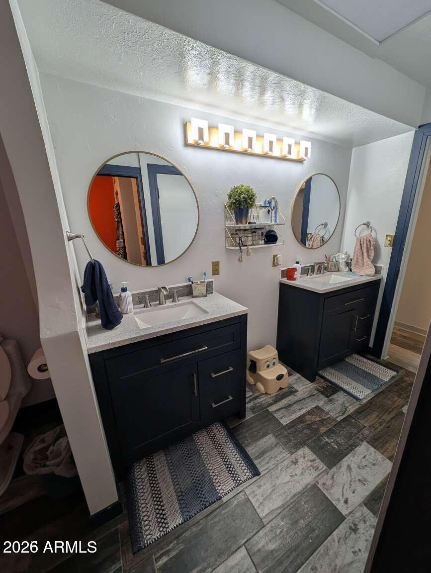 3100 11th Street Douglas, AZ 85607 - Photo 8 of 16 a bathroom with a sink and a mirror