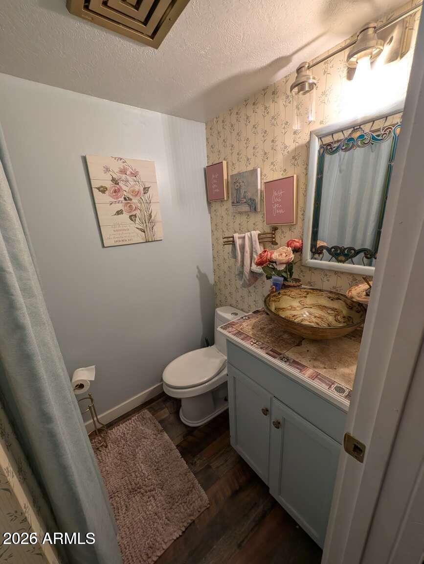 3100 11th Street Douglas, AZ 85607 - Photo 10 of 16 a bathroom with a toilet sink and mirror