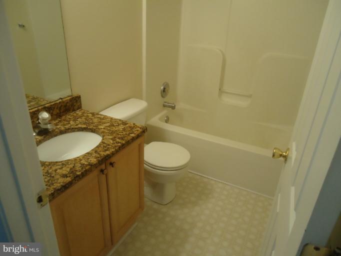 146 Ranson Estates Circle Ranson, WV 25438 - Photo 11 of 12 a bathroom with a granite countertop sink toilet and shower
