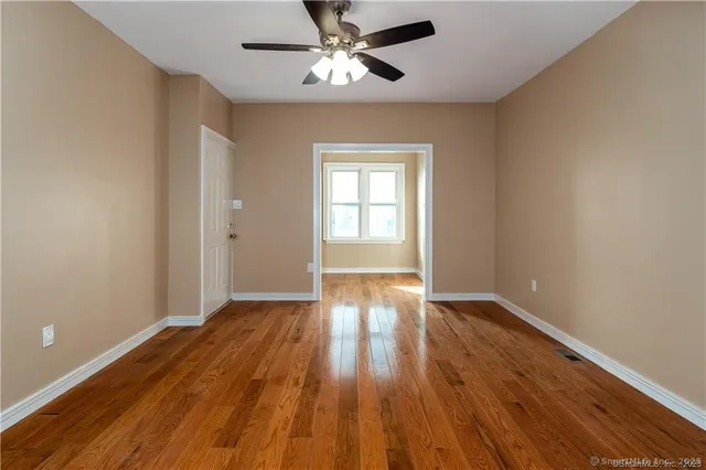 wooden floor in an empty room with a window