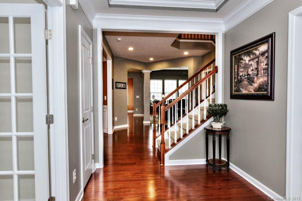 1621 Ridgehaven Road, Unit 240 Waxhaw, NC 28173 - Photo 2 of 24 a dinning room with wooden floor and stairs