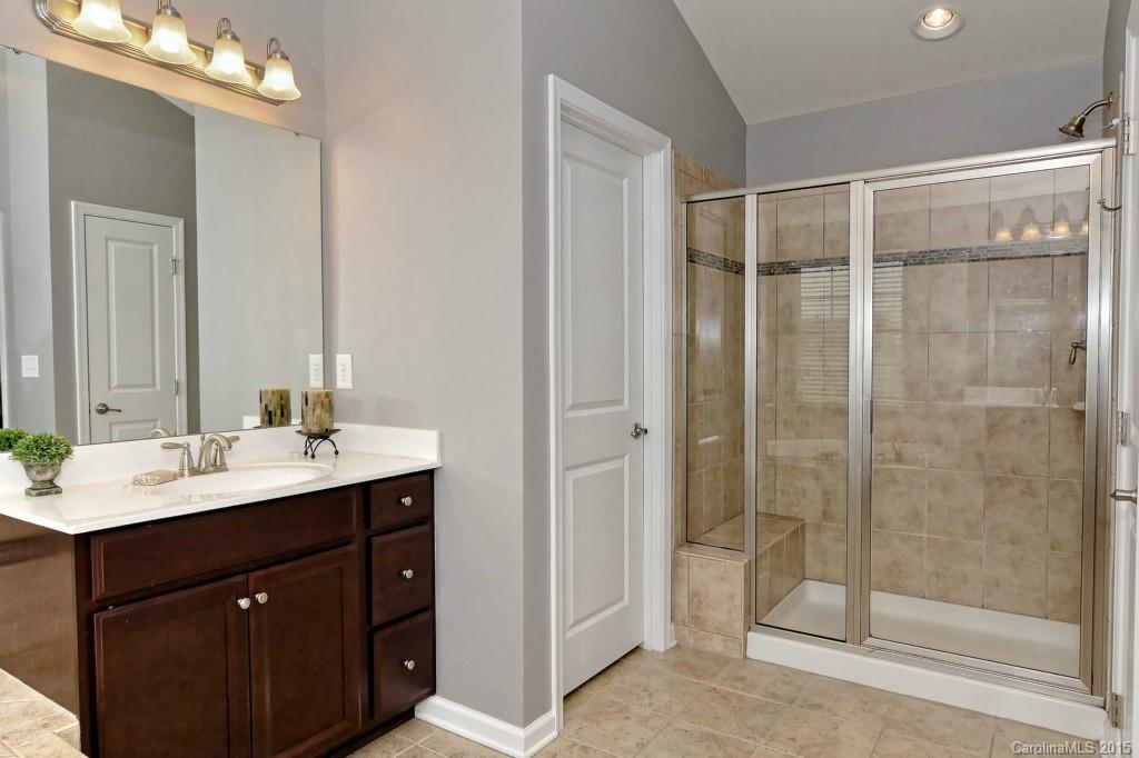 1621 Ridgehaven Road, Unit 240 Waxhaw, NC 28173 - Photo 14 of 24 a bathroom with a shower sink and mirror