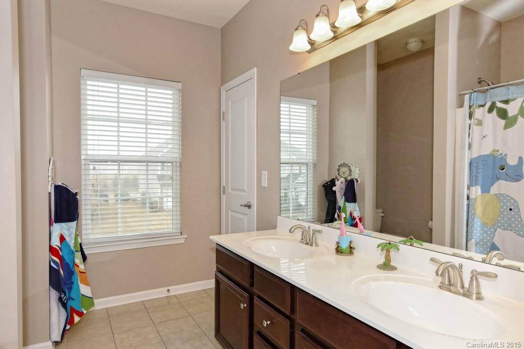 1621 Ridgehaven Road, Unit 240 Waxhaw, NC 28173 - Photo 17 of 24 a bathroom with a sink double vanity and a mirror