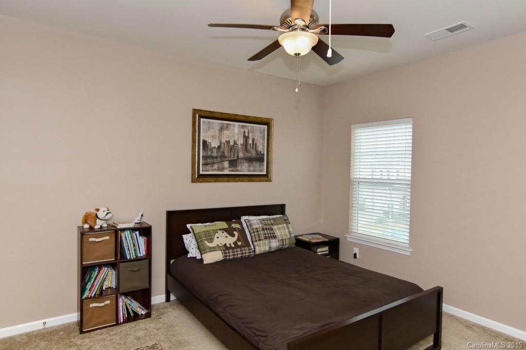1621 Ridgehaven Road, Unit 240 Waxhaw, NC 28173 - Photo 18 of 24 a bed sitting in a bedroom next to a window