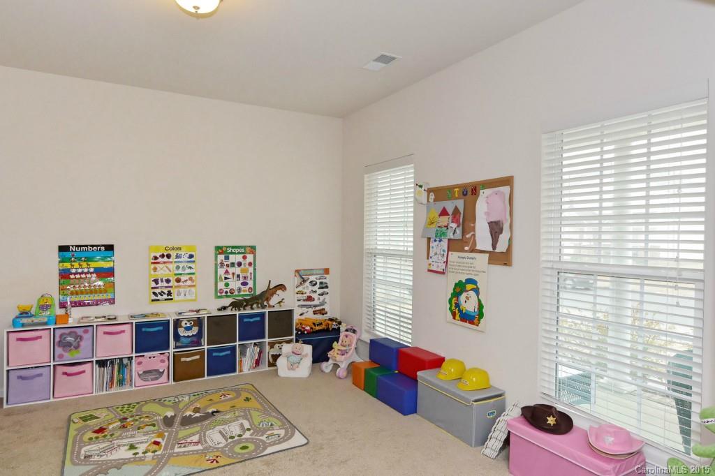 1621 Ridgehaven Road, Unit 240 Waxhaw, NC 28173 - Photo 5 of 24 a bedroom with furniture and a book shelf