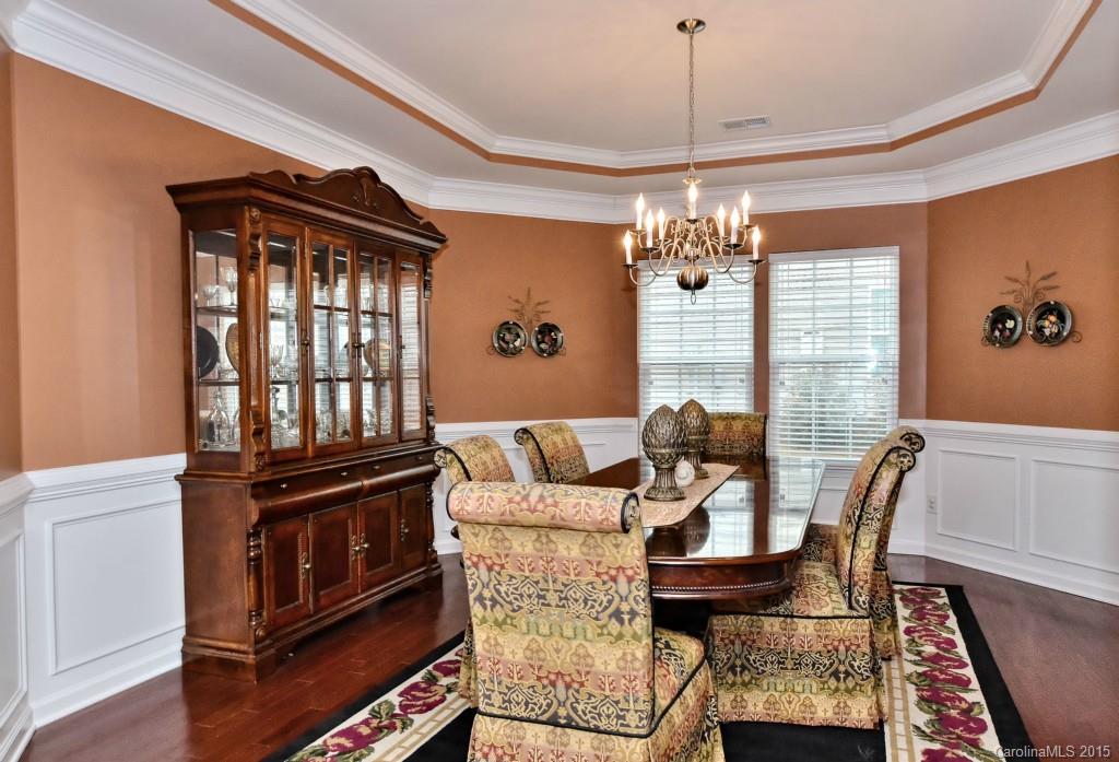 1621 Ridgehaven Road, Unit 240 Waxhaw, NC 28173 - Photo 6 of 24 a view of a dining room with furniture and chandelier