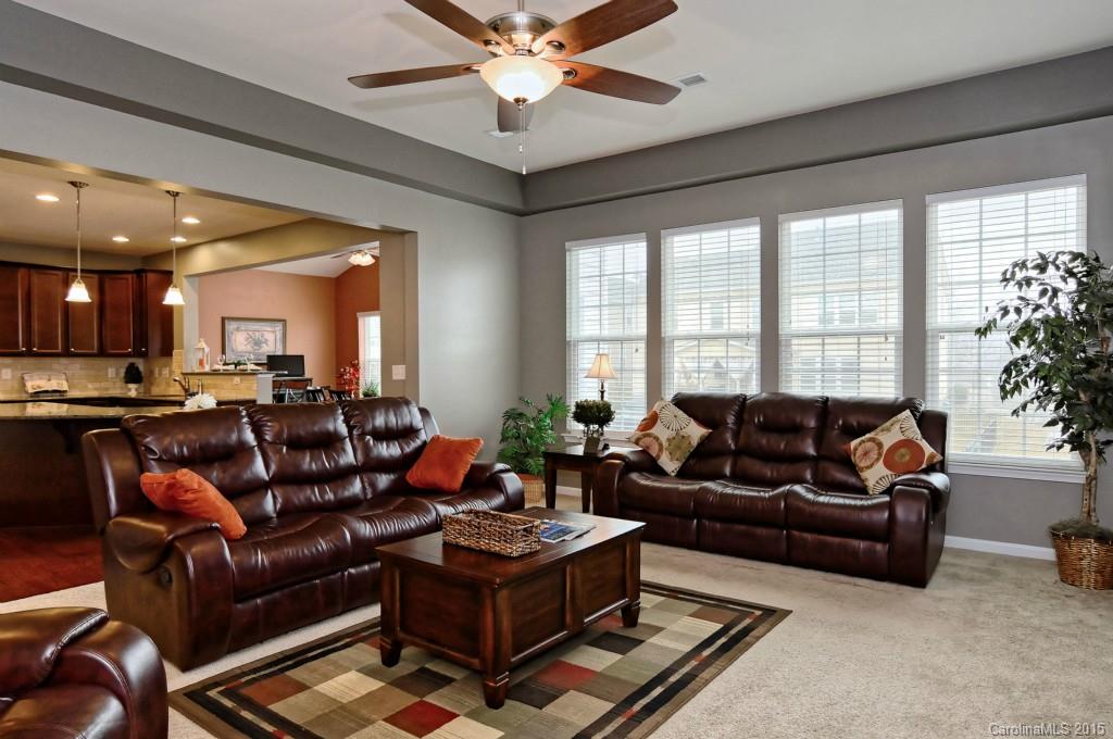 1621 Ridgehaven Road, Unit 240 Waxhaw, NC 28173 - Photo 7 of 24 a living room with furniture ceiling fan and a large window