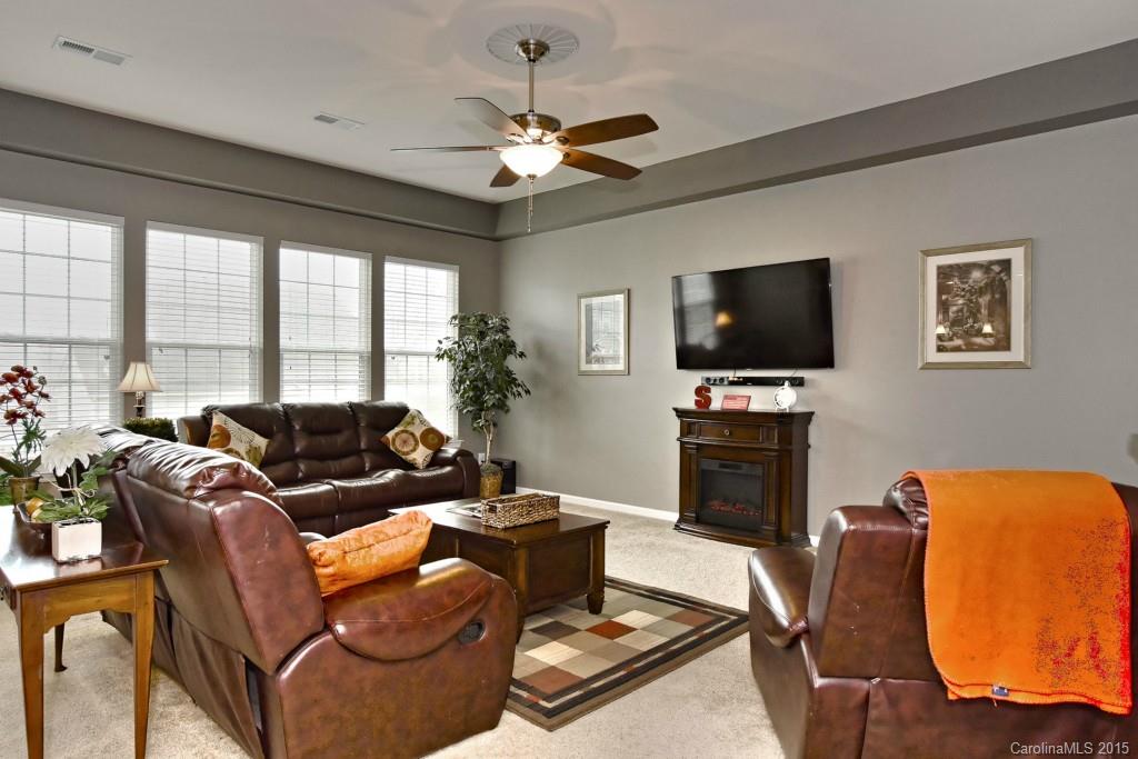 1621 Ridgehaven Road, Unit 240 Waxhaw, NC 28173 - Photo 8 of 24 a living room with furniture a flat screen tv and a large window