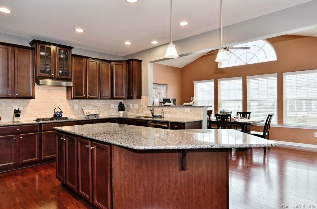 1621 Ridgehaven Road, Unit 240 Waxhaw, NC 28173 - Photo 9 of 24 a large kitchen with granite countertop lots of counter space a sink and a large window