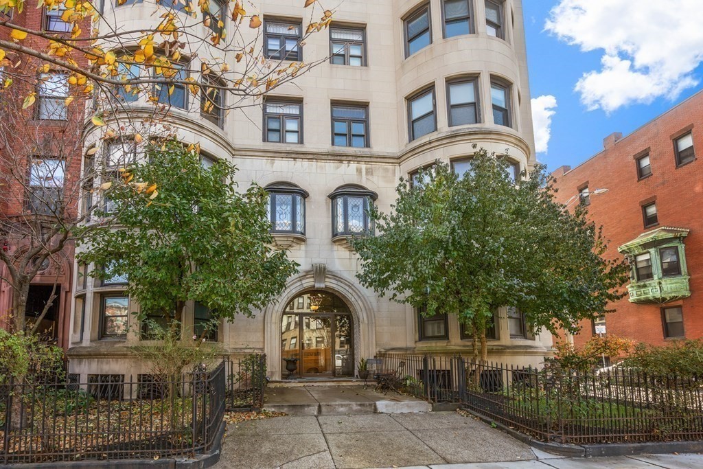 857 Beacon Street, Unit 23 Boston, MA 02215 - Photo 13 of 15 a front view of a residential apartment building with a yard