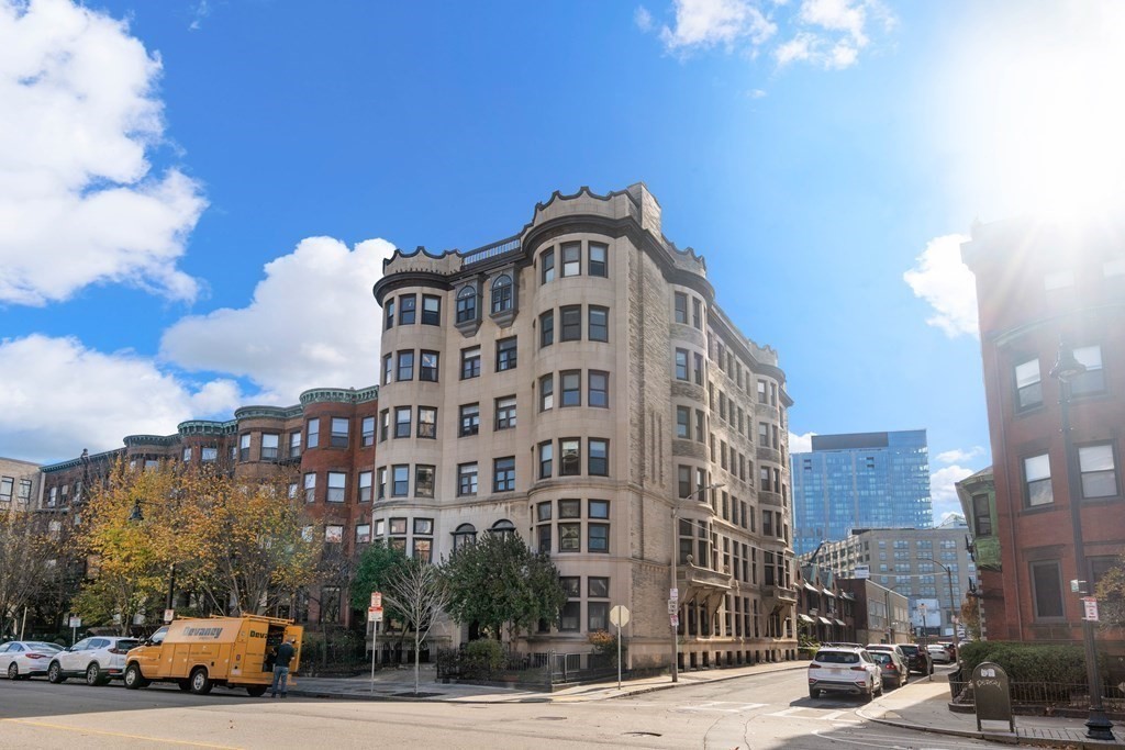 857 Beacon Street, Unit 23 Boston, MA 02215 - Photo 15 of 15 a front view of a building with lot of cars and trees