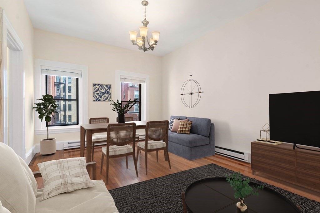 857 Beacon Street, Unit 23 Boston, MA 02215 - Photo 2 of 15 a living room with furniture a chandelier and a flat screen tv