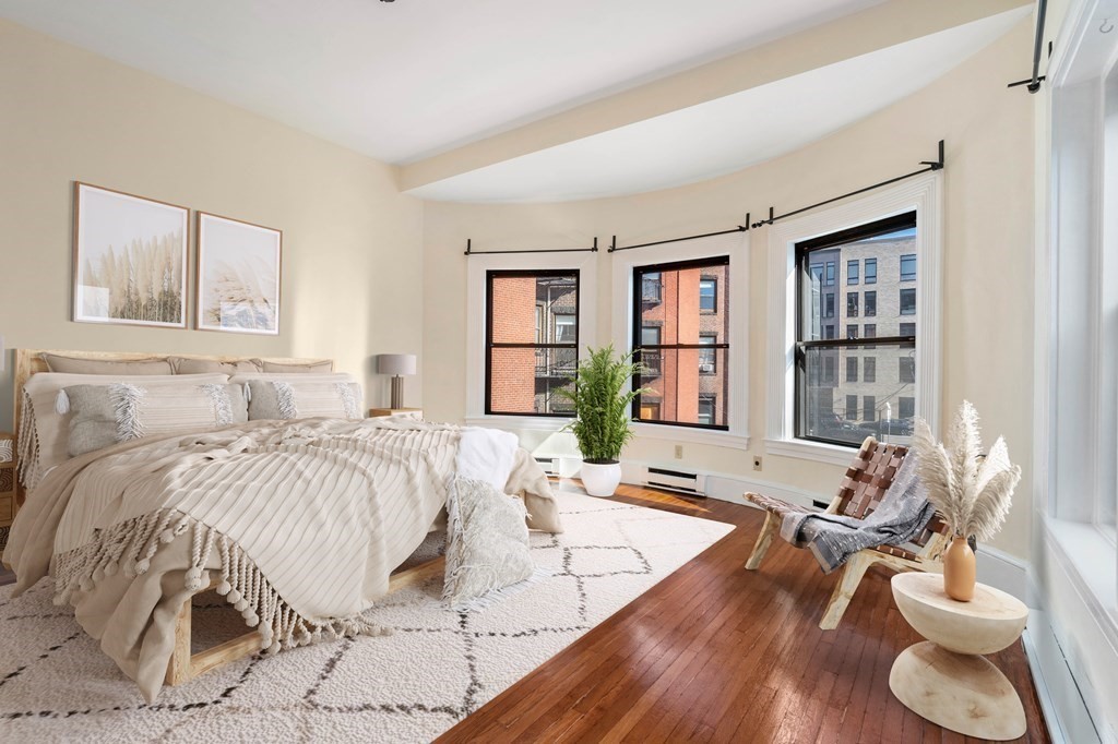 857 Beacon Street, Unit 23 Boston, MA 02215 - Photo 3 of 15 a bed sitting in a bedroom next to a large window