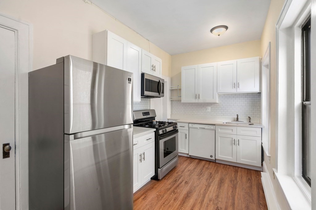 857 Beacon Street, Unit 23 Boston, MA 02215 - Photo 8 of 15 a kitchen with stainless steel appliances a refrigerator sink and microwave