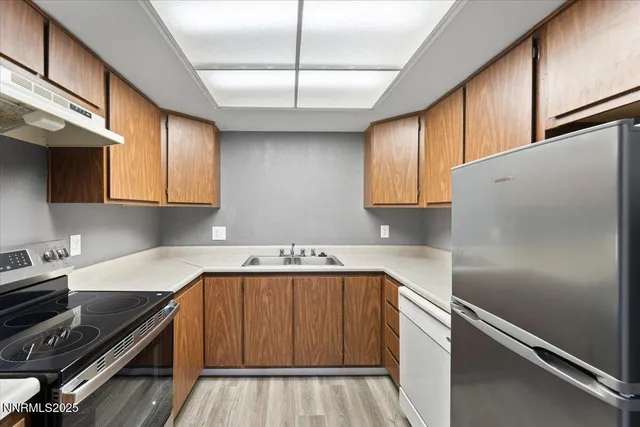 a kitchen with a refrigerator and a stove