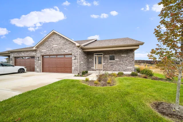 a front view of a house with a yard and garage