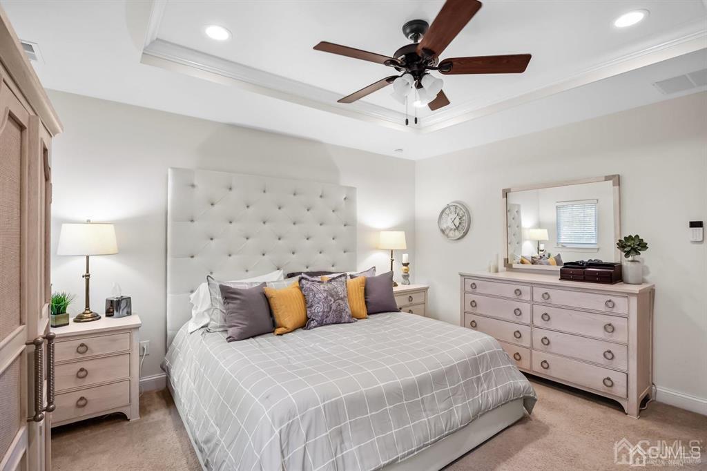 55 Isabelle Court Evesham, NJ 08053 - Photo 23 of 37 a bedroom with a large bed and a chandelier