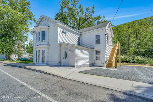 a front view of a house with garage
