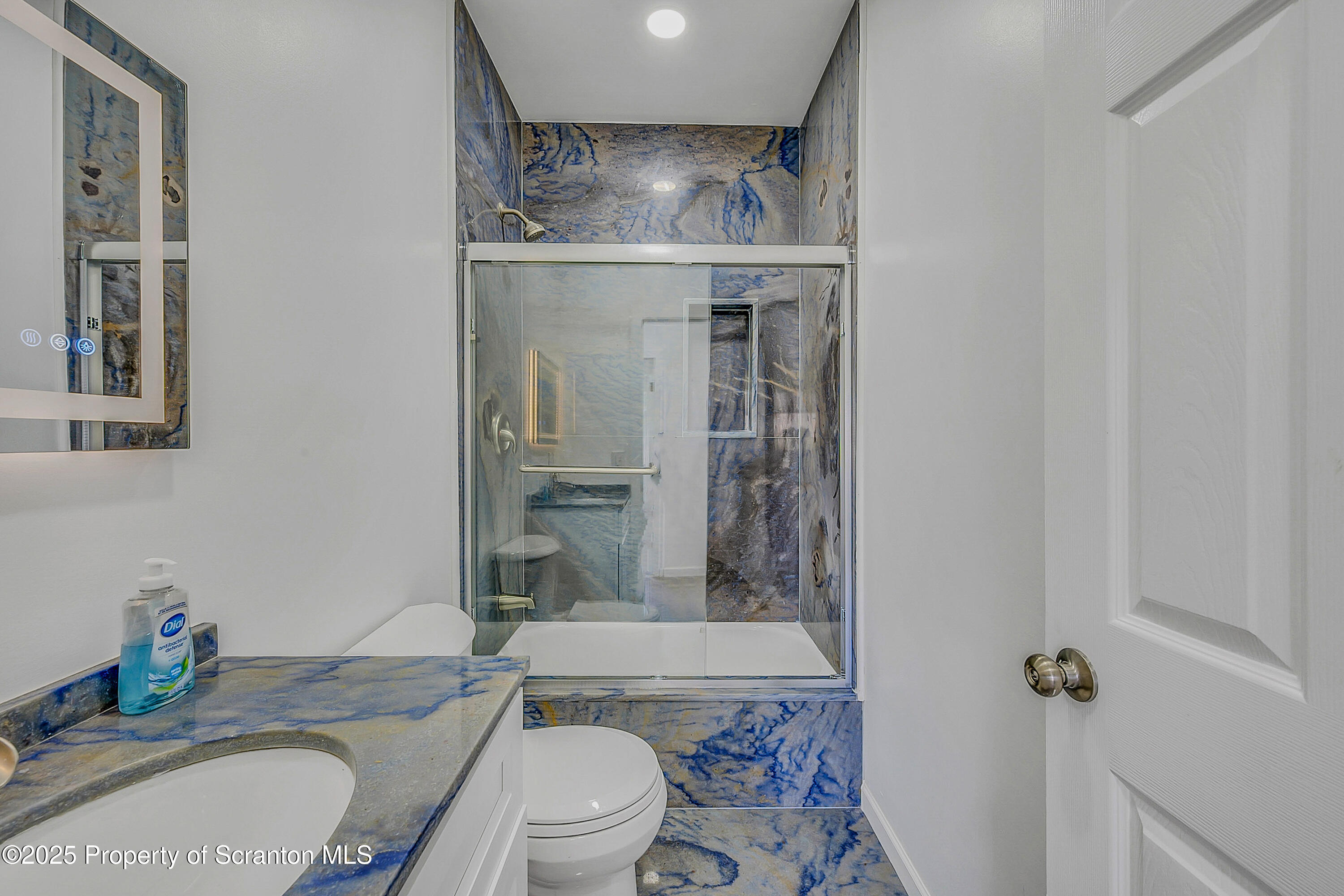218 East Main Street Susquehanna, PA 18847 - Photo 11 of 43 a bathroom with a granite countertop toilet sink and shower