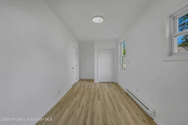 a view of wooden floor in an empty room