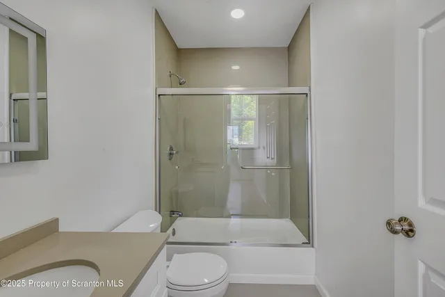 a bathroom with a toilet and shower