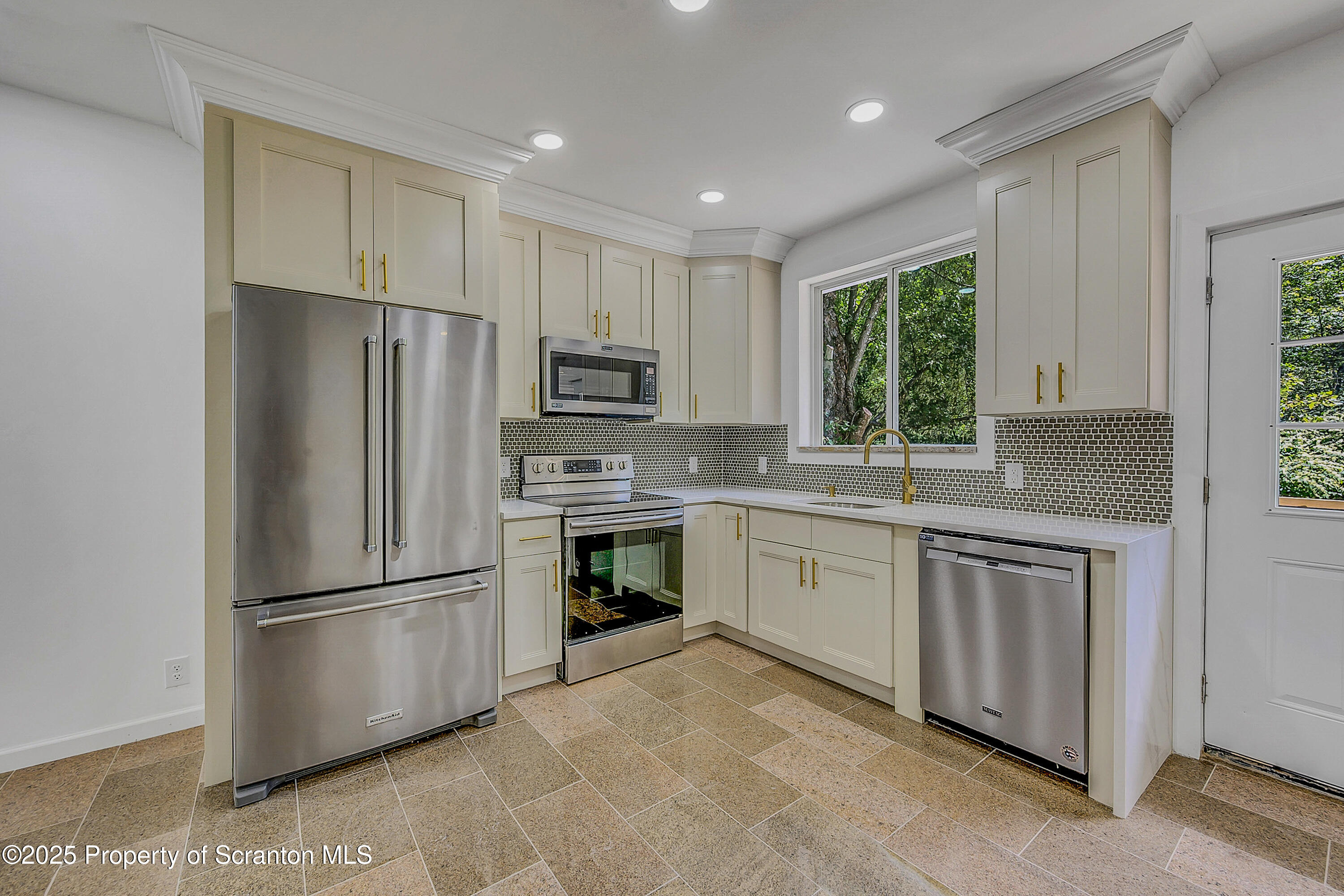 218 East Main Street Susquehanna, PA 18847 - Photo 20 of 43 a kitchen with kitchen island granite countertop appliances cabinets and a sink