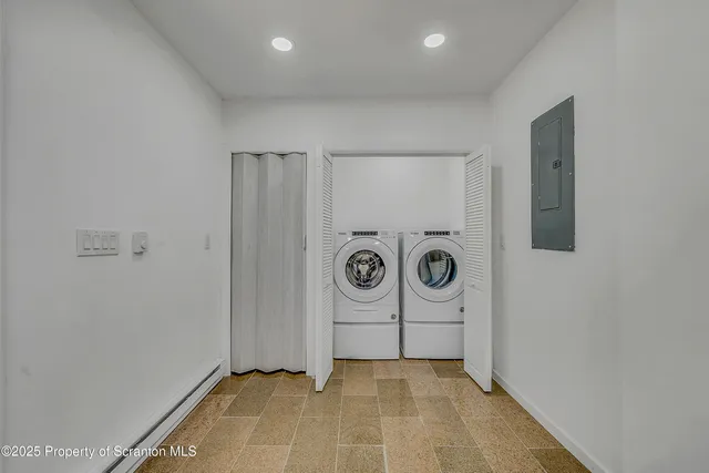 a view of a storage & utility room with a washer dryer