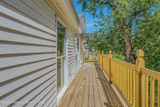 a view of balcony with wooden floor and fence